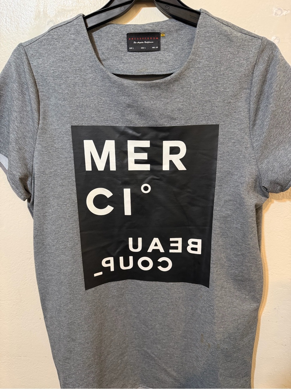 Dress Forum Gray Graphic Tee with Black 'MERCI' Block